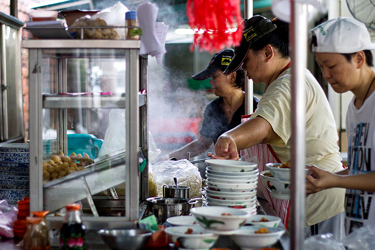Busy dishing up the famous Tengkera prawn cracker noodles in Melaka.