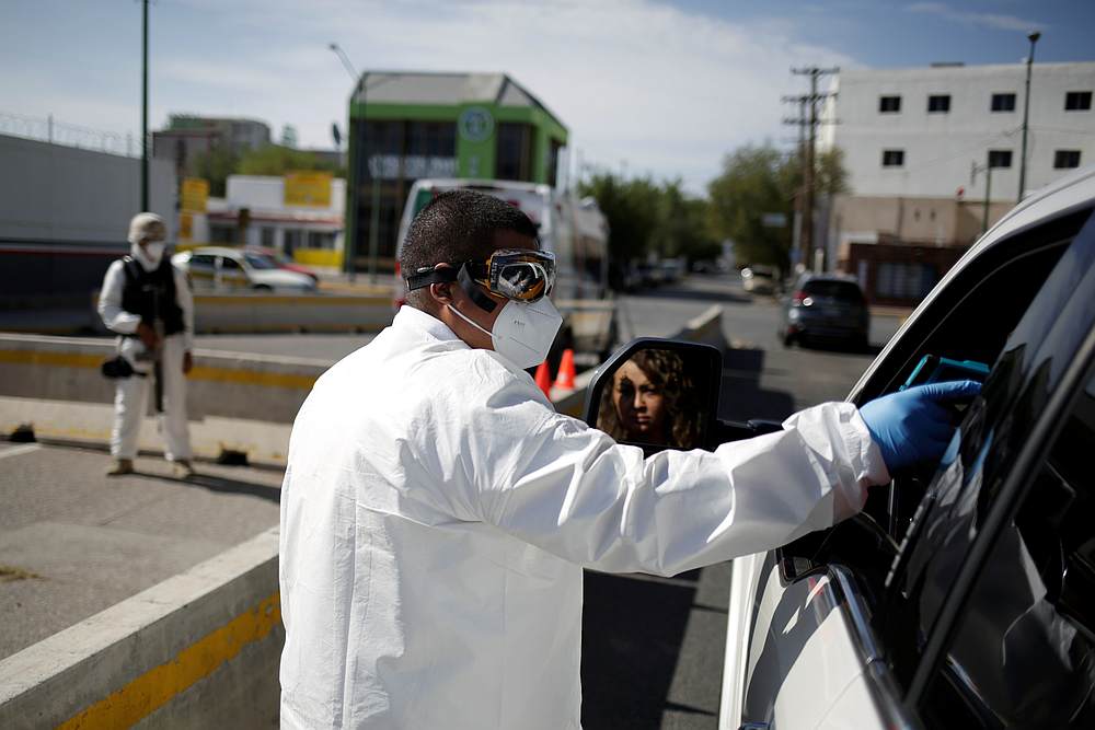 Mexican paramedic checks the temperature of a traveller as she enters to Ciudad Jurez, Mexico from the United States in Ciudad Juarez, Mexico July 4, 2020. u00e2u20acu201d Reuters pic