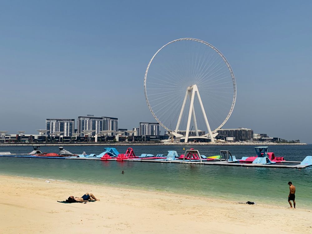 A man sunbathes along the Marina beach near the Ain Dubai Ferris wheel in the Gulf emirate of Dubai on July 7, 2020. u00e2u20acu201d AFP pic