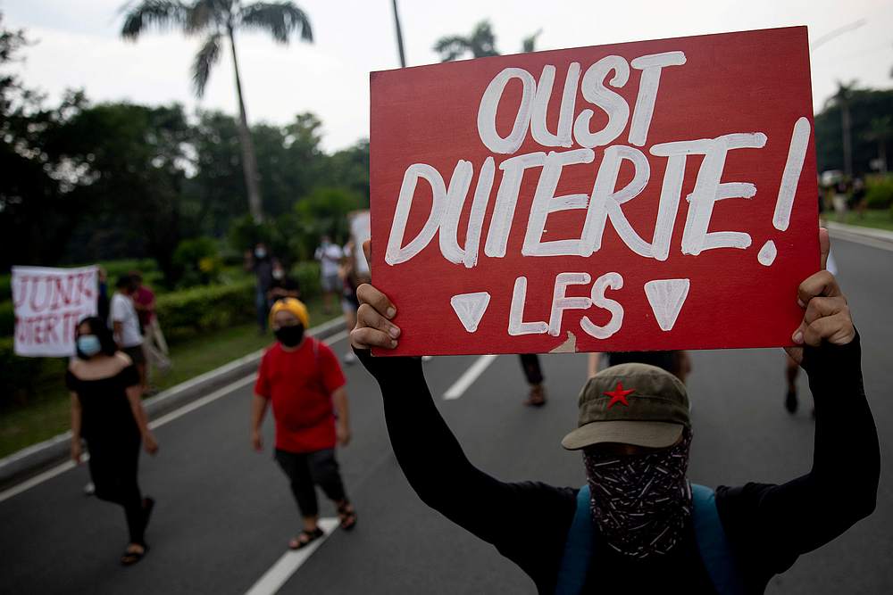 A protester raises a placard that says 'Oust Duterte' during a rally against the anti-terror bill approved by President Rodrigo Duterte, in Manila, Philippines July 4, 2020. u00e2u20acu201d Reuters pic