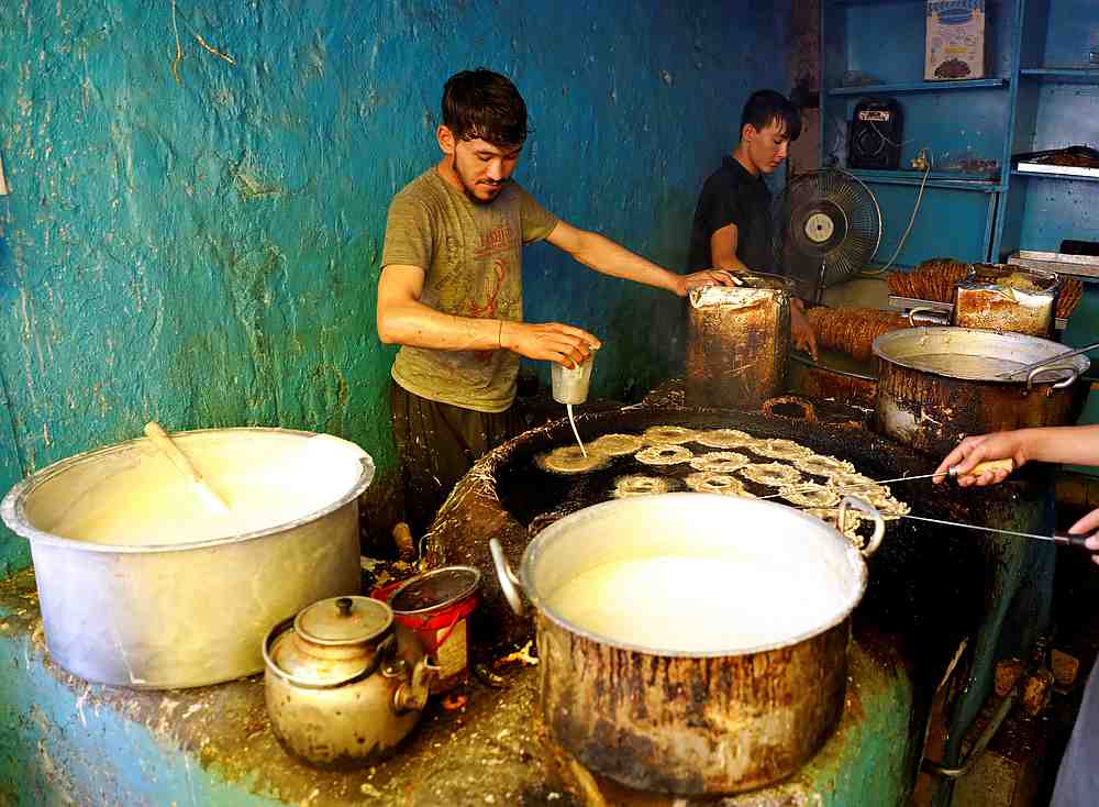 Men make sweets at a small traditional factory in preparation for the Eid al-Adha, amid the spread of Covid-19, in Kabul, Afghanistan July 29, 2020. u00e2u20acu201d Reuters pic