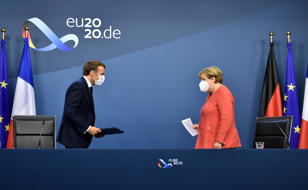 German Chancellor Angela Merkel and French President Emmanuel Macron leave after their joint video press conference at the end of the European summit at the EU headquarters in Brussels July 21, 2020. u00e2u20acu201d AFP pic 