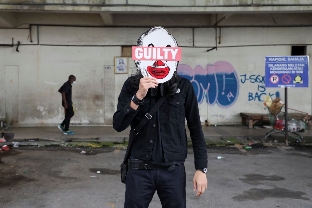 Activist Fahmi Reza poses for a picture holding his artwork bearing an image of former Prime Minister Datuk Seri Najib Razak during an interview in Kuala Lumpur July 29, 2020.u00e2u20acu201d Reuters pic