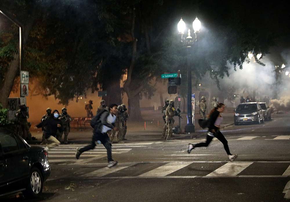 Federal law enforcement officials fire tear gas and other non lethal methods at demonstrators during a protest against racial inequality in Portland, Oregon July 19, 2020. u00e2u20acu201d Reuters pic 