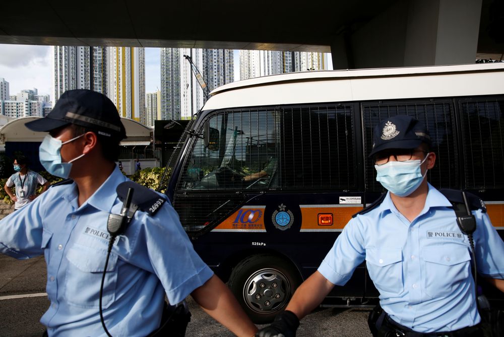 Police officers escort a prison van which is carrying Tong Ying-kit, the first person charged under the new national security law, as he leaves West Kowloon Magistratesu00e2u20acu2122 Courts, in Hong Kong, China July 6, 2020. u00e2u20acu201d Reuters pic