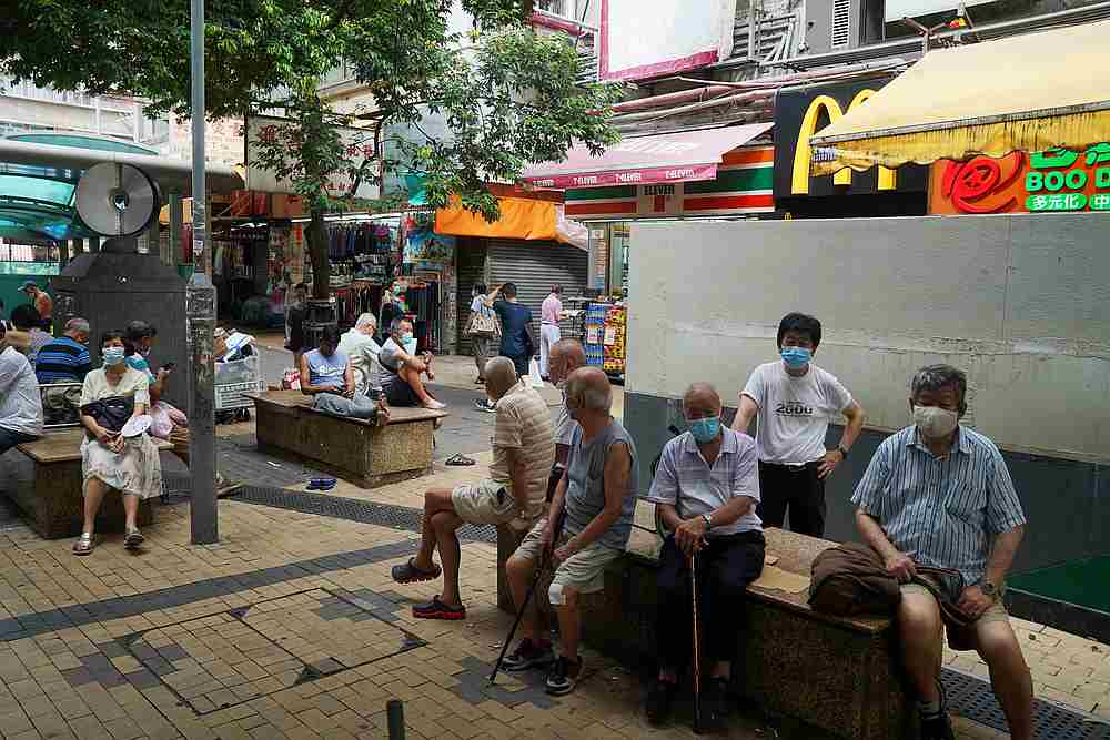People wearing face masks following the Covid-19 outbreak sit on benches at a shopping street in Hong Kong July 20, 2020. u00e2u20acu201d Reuters pic