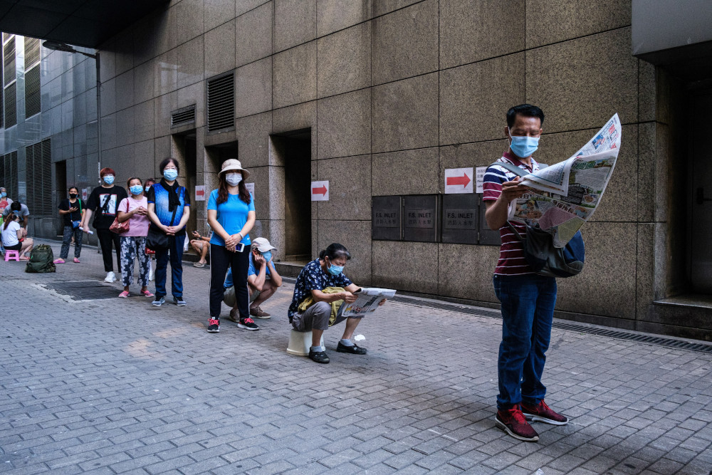 Residents practice social distancing as they line up in the early morning for free Covid-19 test kits handed out at a government clinic in the Kowloon-side Sham Shui Po district of Hong Kong July 29, 2020. u00e2u20acu201d AFP pic 