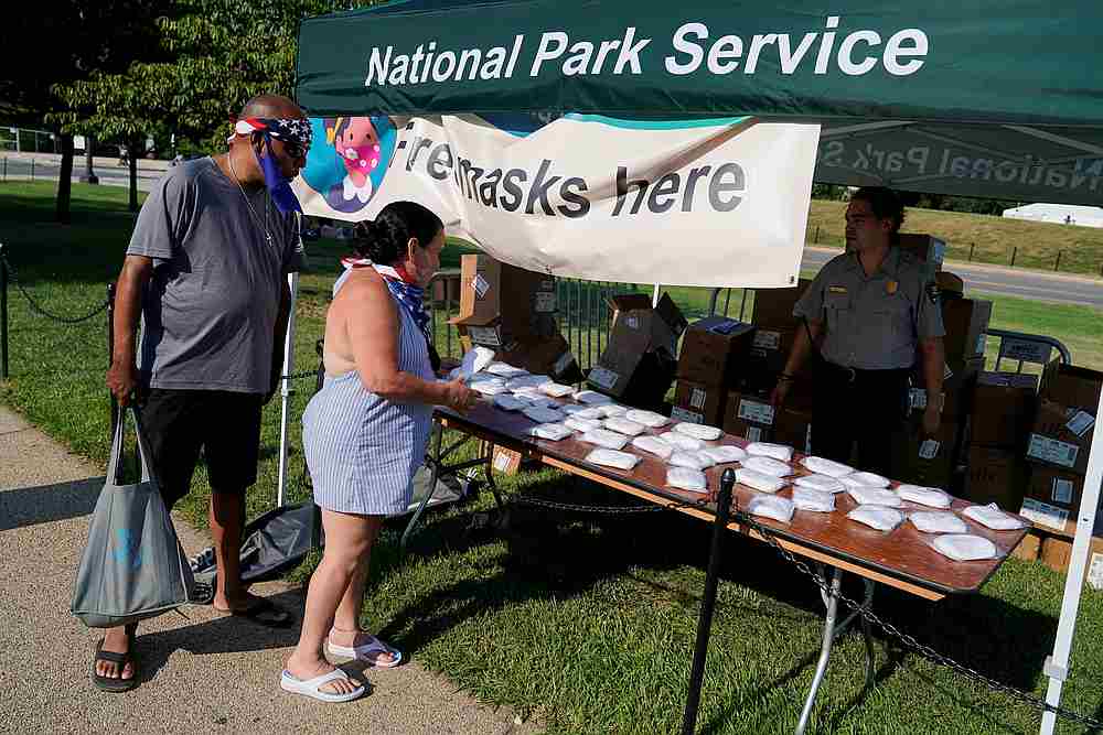 People collect free face masks from the National Park Service on the National Mall before scheduled fireworks celebrating Independence Day in Washington July 4, 2020. u00e2u20acu201d Reuters pic