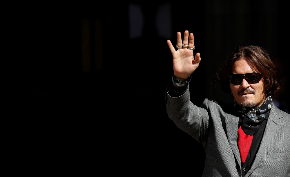 Actor Johnny Depp gestures as he arrives to the High Court in London, Britain, July 21, 2020. u00e2u20acu201d Reuters pic