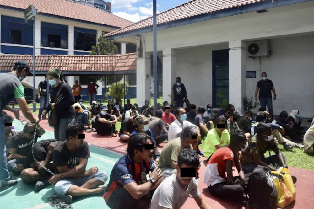 Drug suspects are rounded-up by the police after they were nabbed during the Ops Sarang Khas anti-narcotics operations in Johor July 21, 2020. — Picture courtesy of the Johor Police Contingent