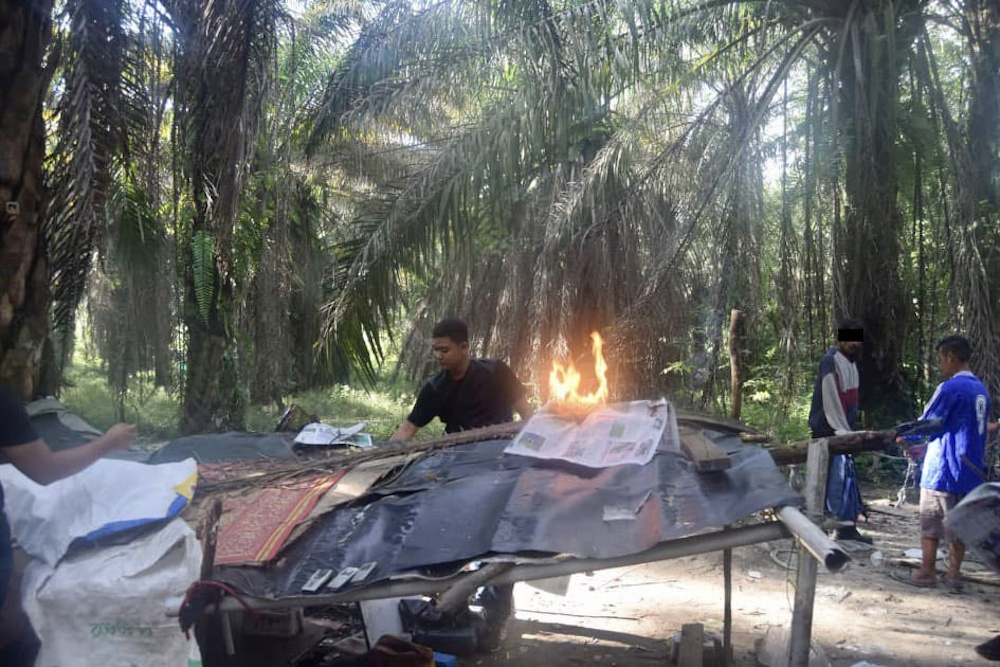 Police destroy a makeshift hut that served as a drug den in Johor during the Ops Sarang Khas anti-narcotics operations in the state July 21, 2020.  u00e2u20acu201d Picture courtesy of the Johor Police Contingent