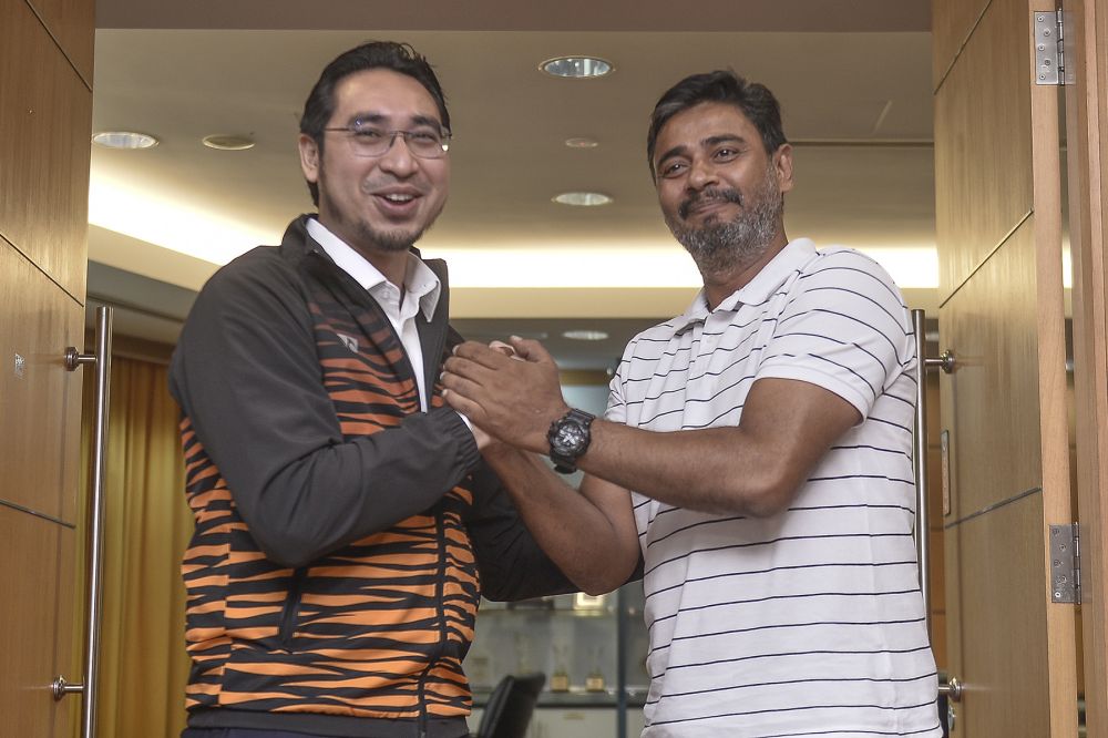 Deputy Youth and Sports Minister Wan Ahmad Fayhsal Wan Ahmad Kamal (left) and Khalid Jamlus pose for the camera during a press conference in Putrajaya July 8, 2020. u00e2u20acu201d Picture by Miera Zulyana