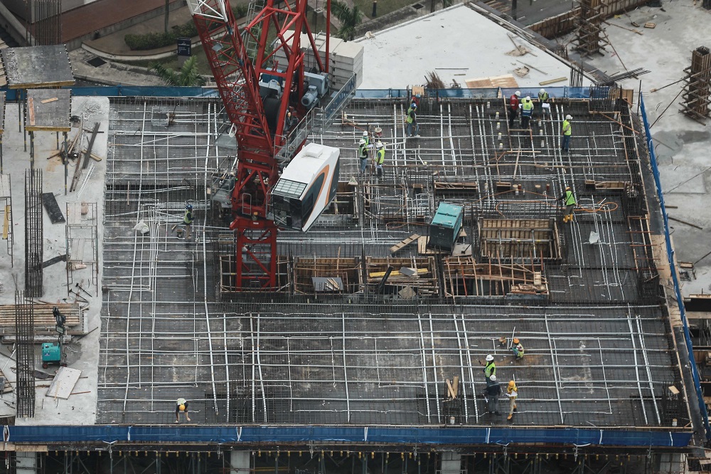 Construction workers are seen at the top of a building in Kuala Lumpur July 21,2020. u00e2u20acu2022 Picture by Ahmad Zamzahuri