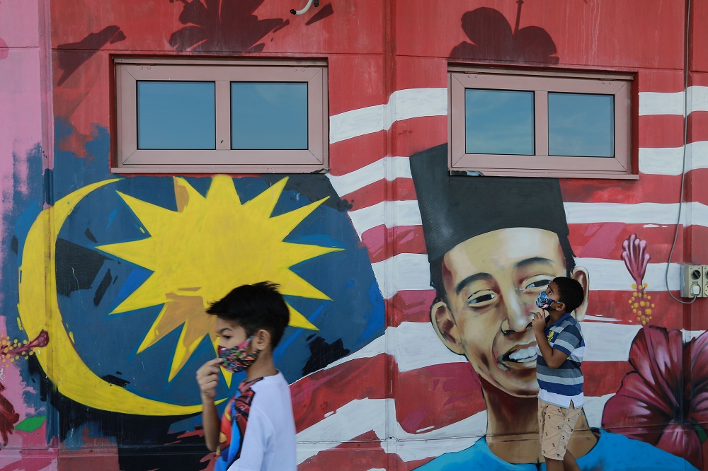 Children walk past a mural in Kuala Lumpur July 21,2020. u00e2u20acu2022 Picture by Ahmad Zamzahuri