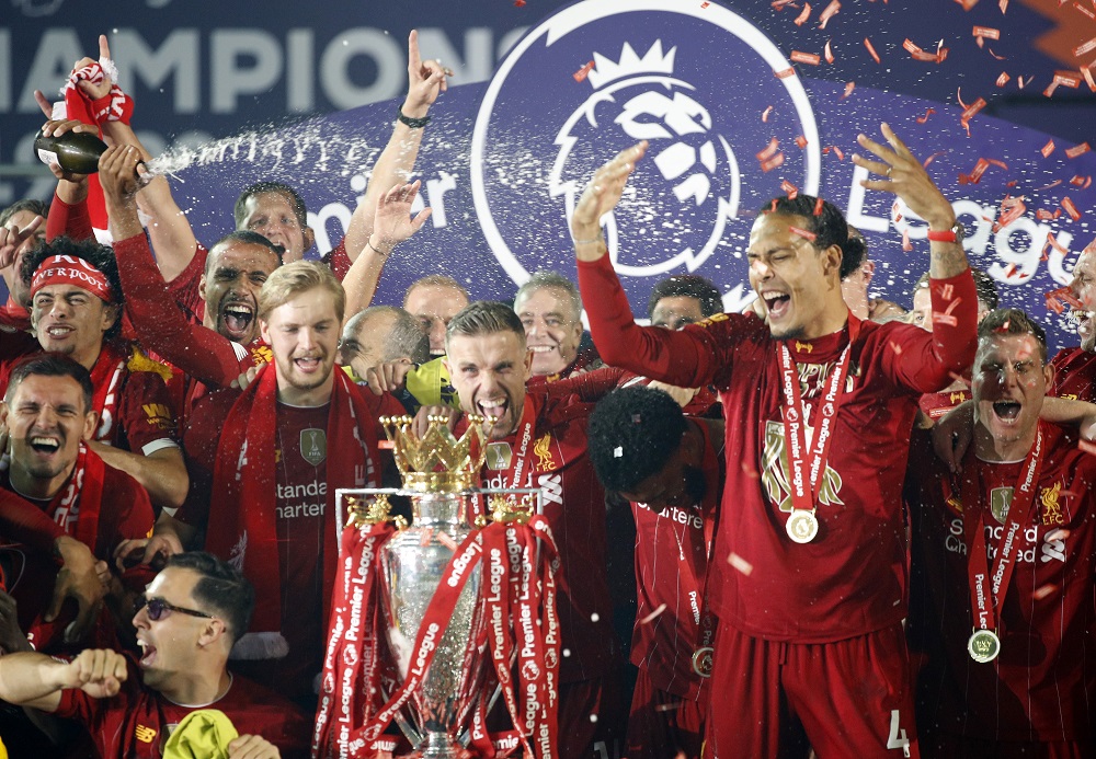 Liverpool's Jordan Henderson and teammates celebrate with the Premier League trophy at Anfield July 23, 2020. u00e2u20acu2022 Reuters pic