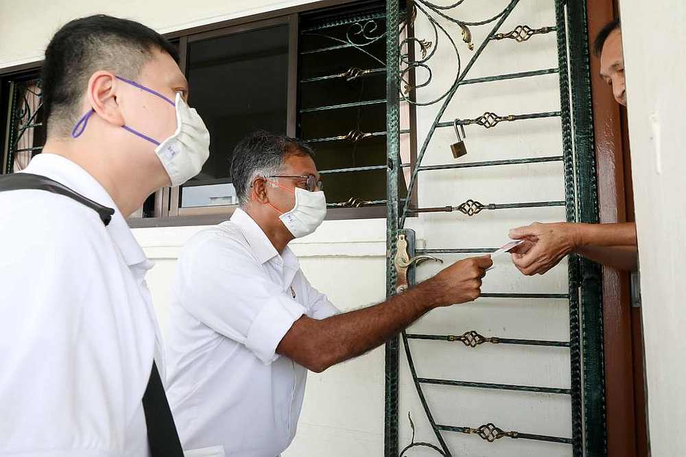 PAPu00e2u20acu2122s Murali Pillai talks to a resident during a house visit at Bukit Batok Block 205, Singapore July 7, 2020. u00e2u20acu201d TODAY pic