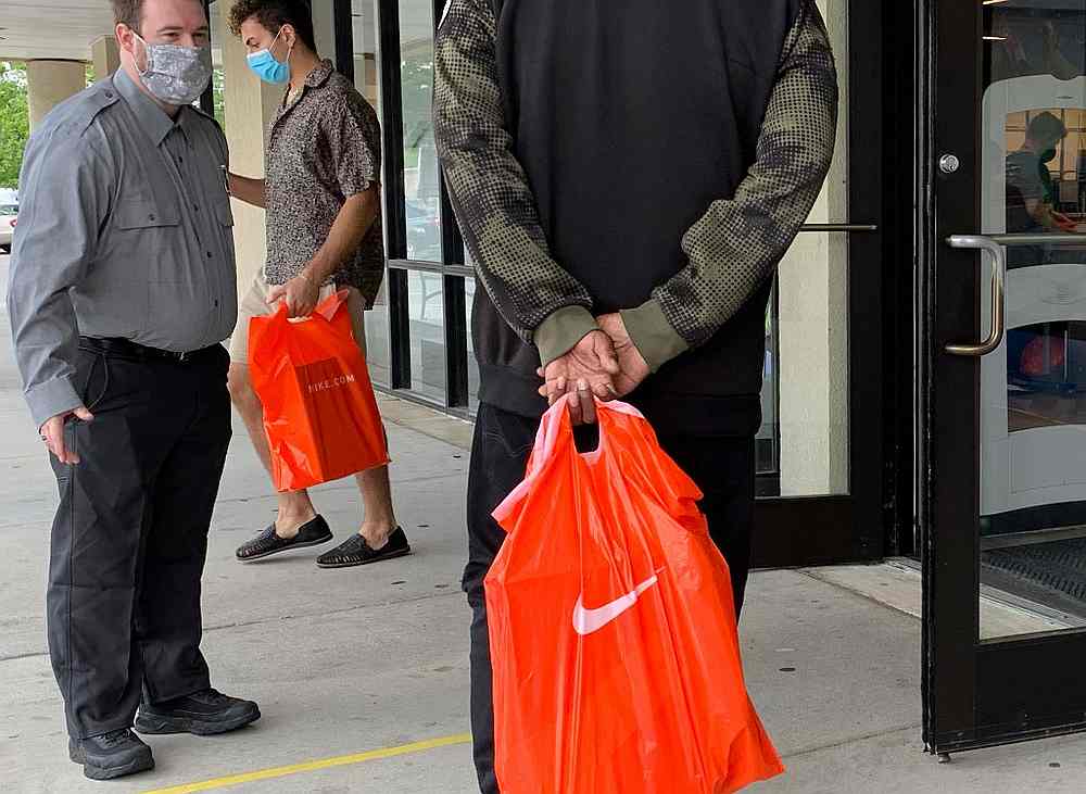 Customers stand in line to get into the Nike Factory store at Queenstown Outlets in Queenstown, Maryland, during the Covid-19 pandemic June 18, 2020. u00e2u20acu201d AFP pic