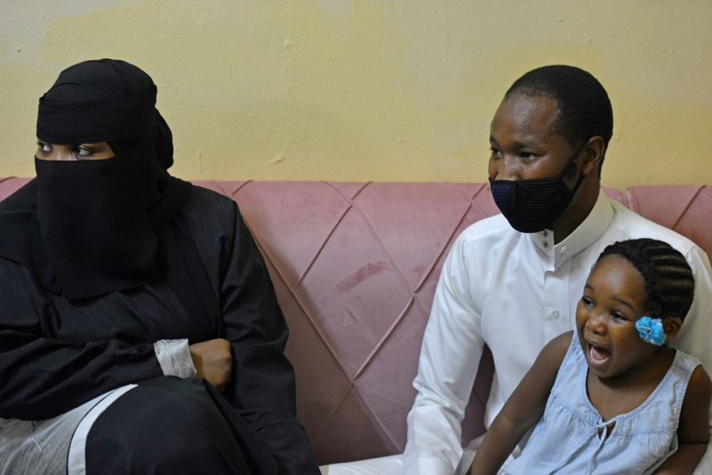 Among the chosen ones whose hajj application was accepted, Nasser Younes Solebarmo (right), a Riyadh-based Nigerian expat, sits near his wife and daughter in Riyadh. u00e2u20acu201d AFP pic