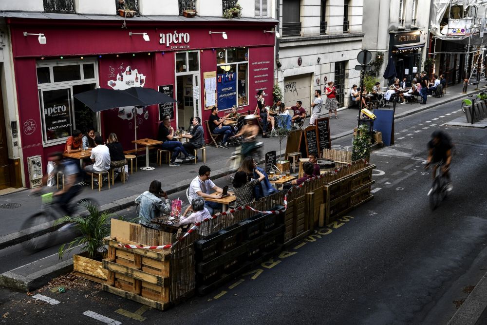 People have drinks at the extended terrace of a cafe made of wooden pallets in Paris July 23, 2020. u00e2u20acu2022 AFP pic