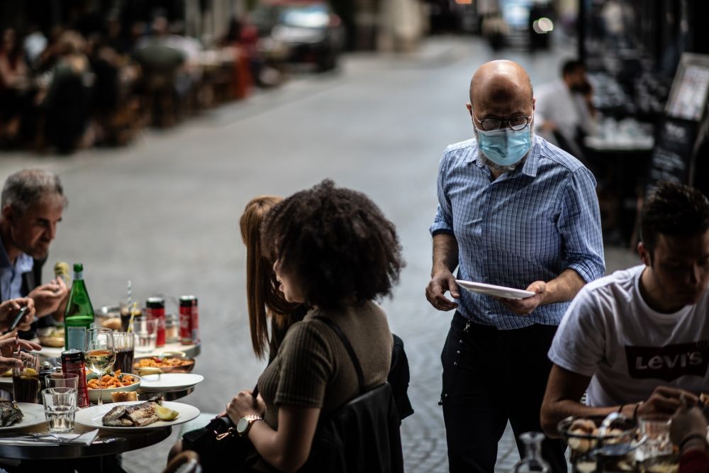A waiter serves customers at a terrace of a restaurant in Paris. u00e2u20acu201d AFP picnn
