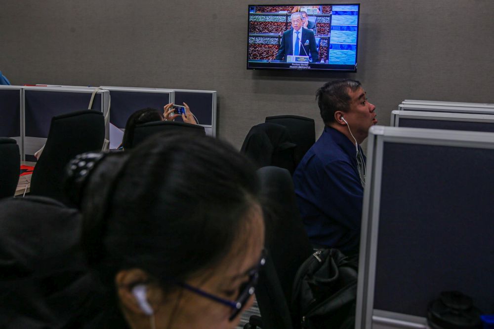 People watch a live broadcast of Prime Minister Tan Sri Muhyiddin Yassin's speech during the second meeting of the third session of the 14th Parliament in Kuala Lumpur July 13, 2020. u00e2u20acu201d Picture by Hari Anggara