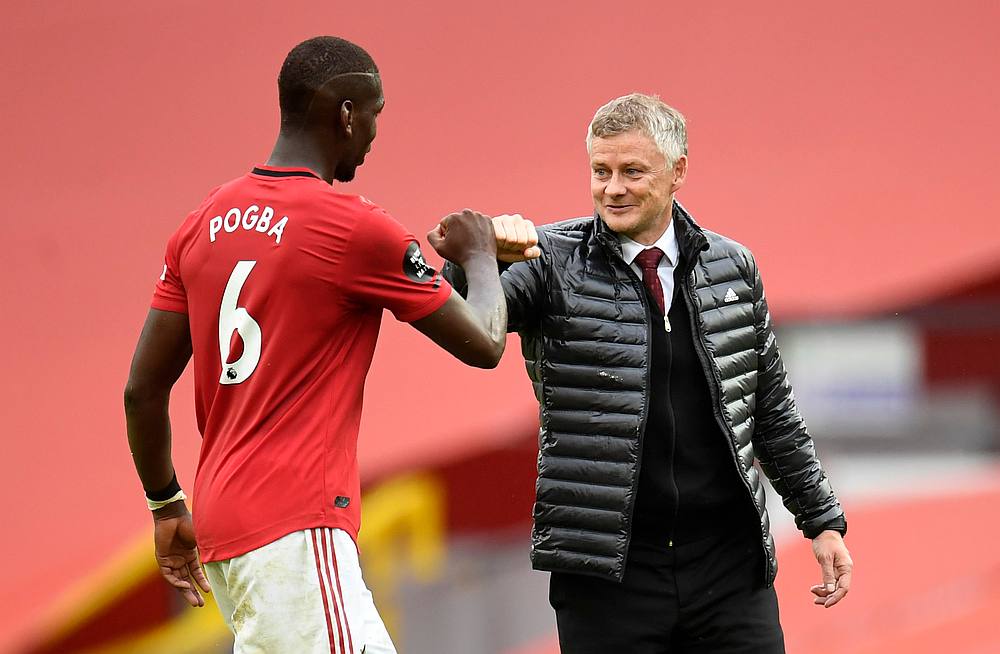 Manchester United manager Ole Gunnar Solskjaer and Paul Pogba celebrate after the EPL match behind closed doors against AFC Bournemouth at Old Trafford, Manchester July 4, 2020. u00e2u20acu201d Peter Powell/Pool pic via Reuters 