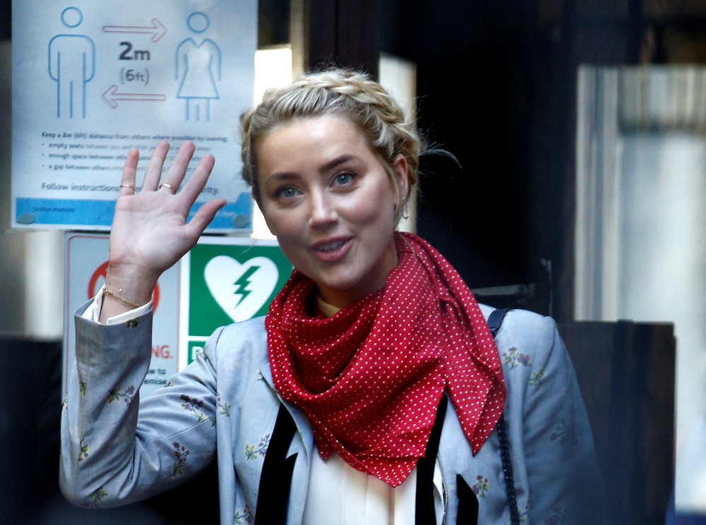 Actor Amber Heard waves as she arrives at the High Court in London July 21, 2020. u00e2u20acu201d Reuters pic