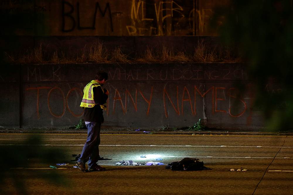 Washington State Patrol investigator inspects the scene where two people in a group of protesters were struck by a car on Interstate 5 during e protest in Seattle, Washington July 4, 2020. u00e2u20acu201d Reuters pic