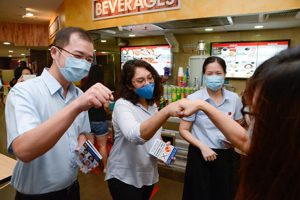 (From left) Louis Chua, Raeesah Khan and He Ting Ru from the Workersu00e2u20acu2122 Party greeting residents at Rivervale Plaza in Sengkang, July 7, 2020. u00e2u20acu201d TODAY pic