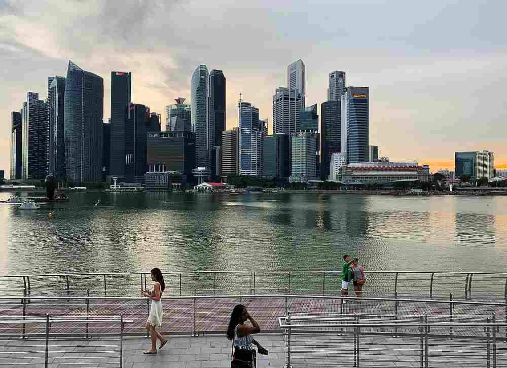 Passers-by walking in front of Singapore's central business district skyline, in Singapore,May 10, 2019. u00e2u20acu201d Reuters pic