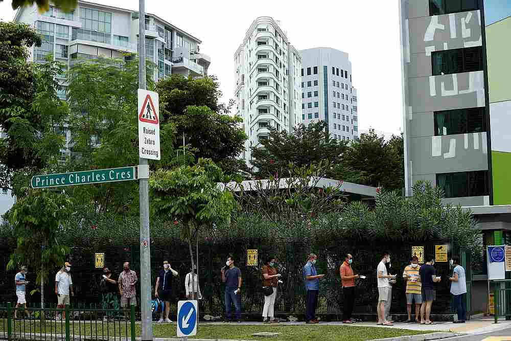 Voters wearing face masks observe social distancing at a polling station during Singapore's general election, amid the Covid outbreak, in Singapore July 10, 2020. u00e2u20acu201d Reuters pic