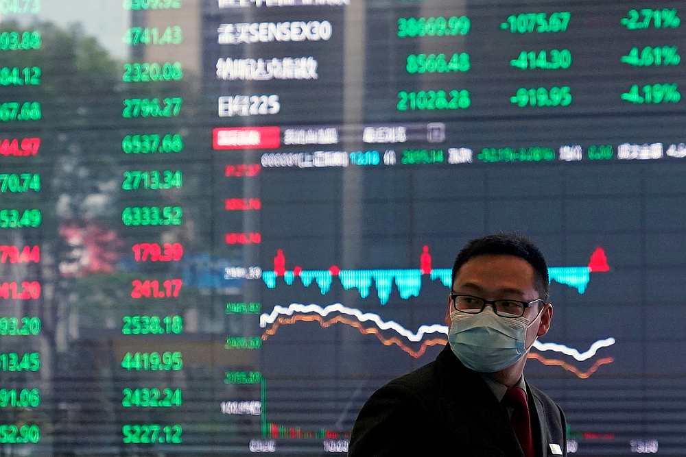 A man wearing a protective mask is seen inside the Shanghai Stock Exchange building at the Pudong financial district in Shanghai, China February 28, 2020. u00e2u20acu201d Reuters pic
