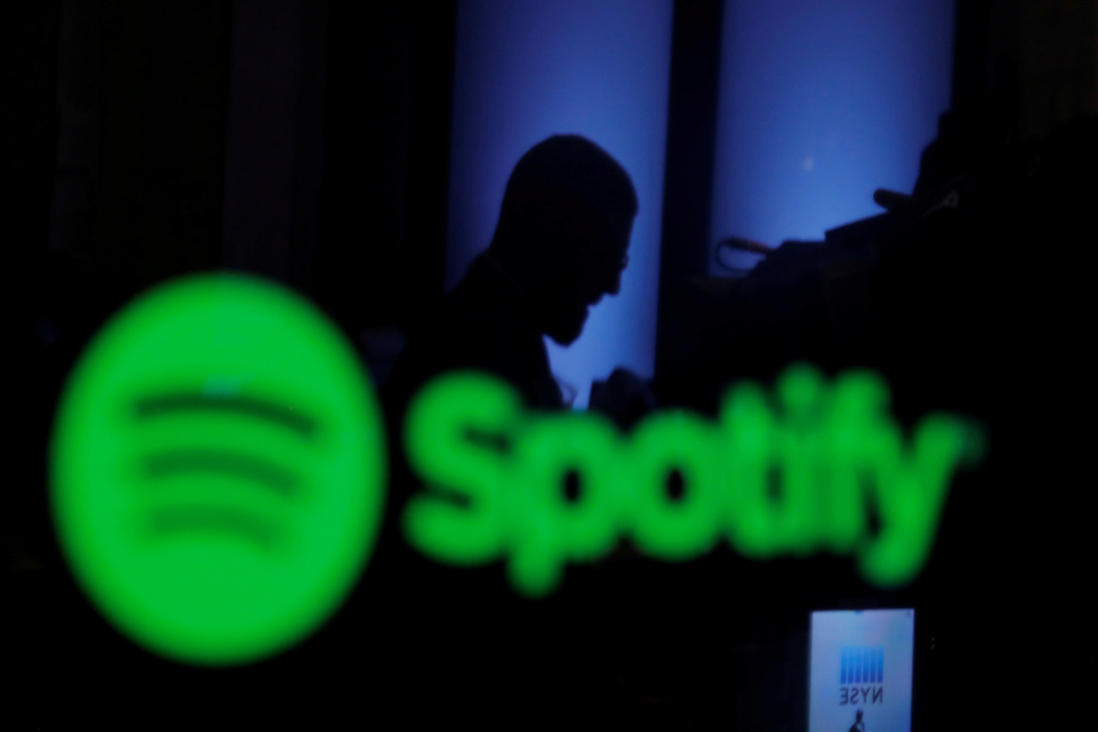 A trader is reflected in a computer screen displaying the Spotify brand before the company begins selling as a direct listing on the floor of the New York Stock Exchange in New York, US, April 3, 2018. u00e2u20acu201d Reuters pic 