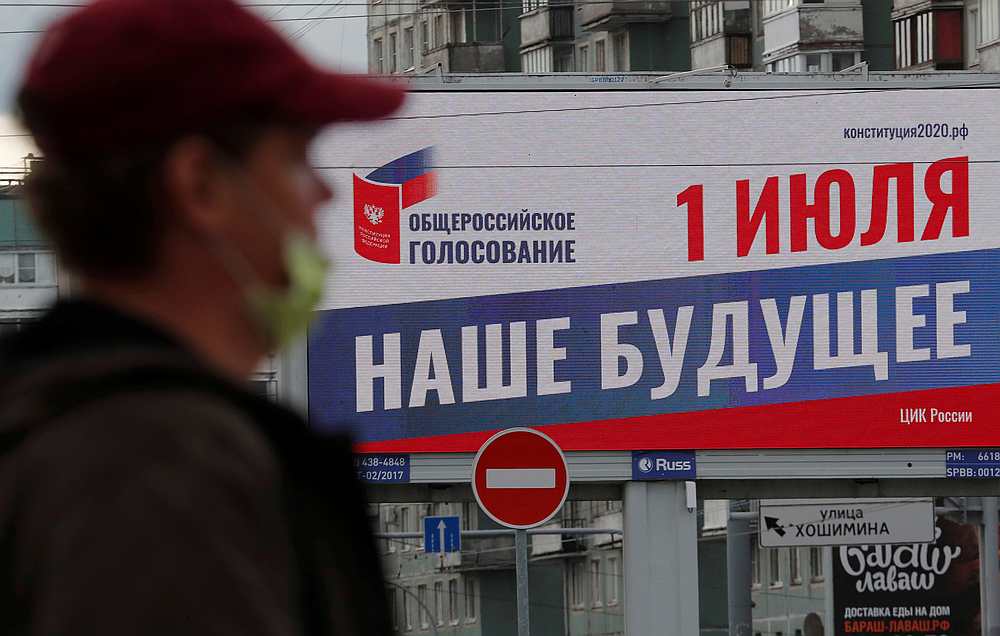 A person wearing a protective face mask walks past a billboard informing about a nationwide vote on constitutional changes, amid the Covid-19 outbreak in St Petersburg, Russia June 5, 2020. u00e2u20acu201d Reuters pic 