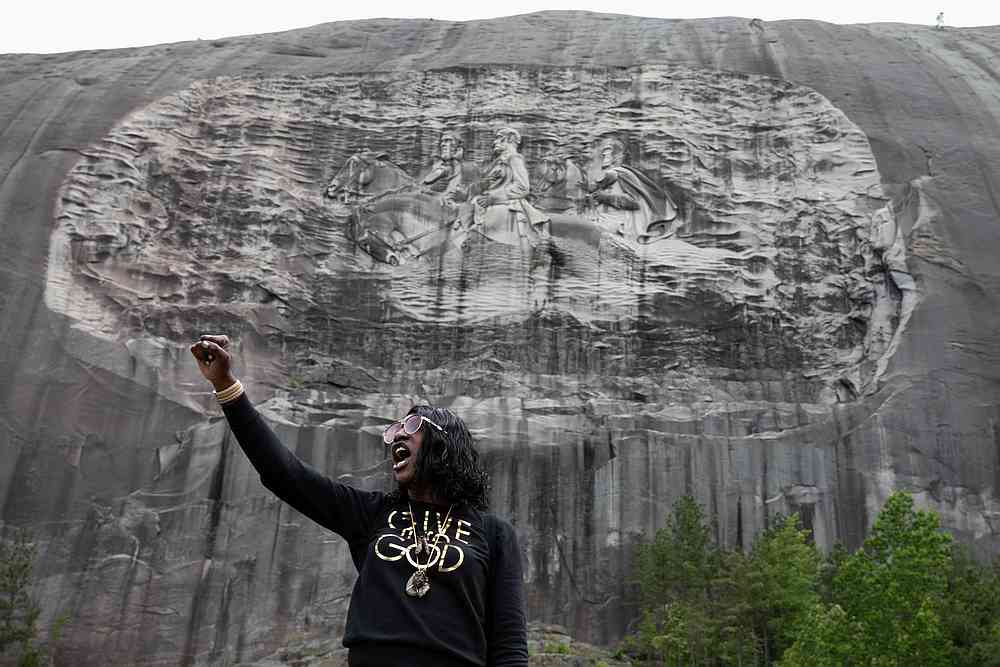 A woman speaks in front of the monument after protesters marched against the Confederate Monument carved into granite at Stone Mountain Park in Stone Mountain, Georgia June 16, 2020. u00e2u20acu201d Reuters pic