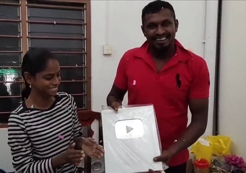 Pavithra and husband M. Sugu showing the Silver Play Button for surpassing 100,000 subscribers. u00e2u20acu201d Screengrab from YouTube