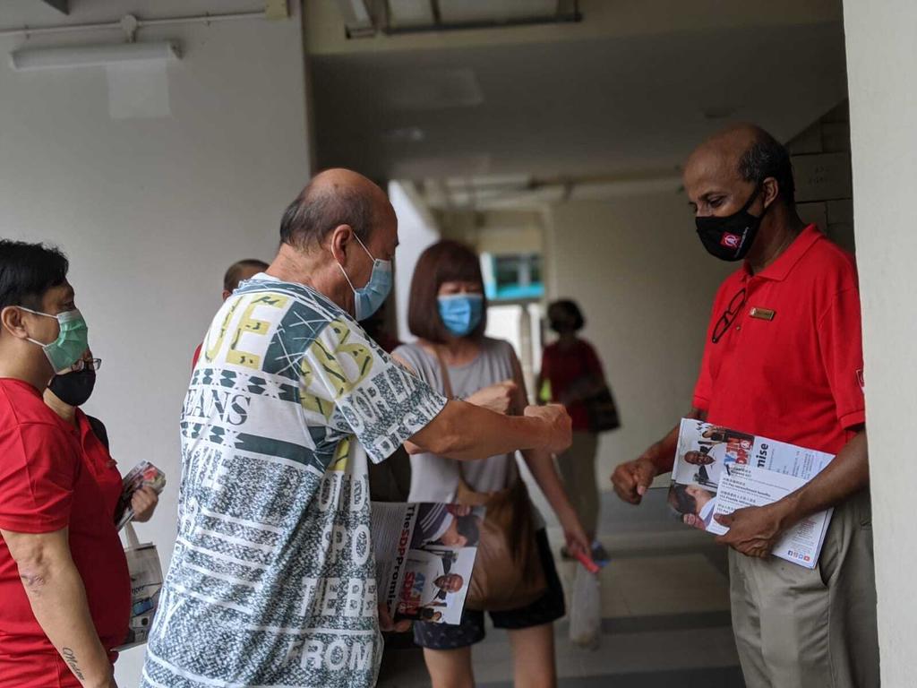Singapore Democratic Party chairman Paul Tambyah (right) makes house visits in Pending Road, Bukit Panjang on July 3, 2020. u00e2u20acu201d TODAY pic
