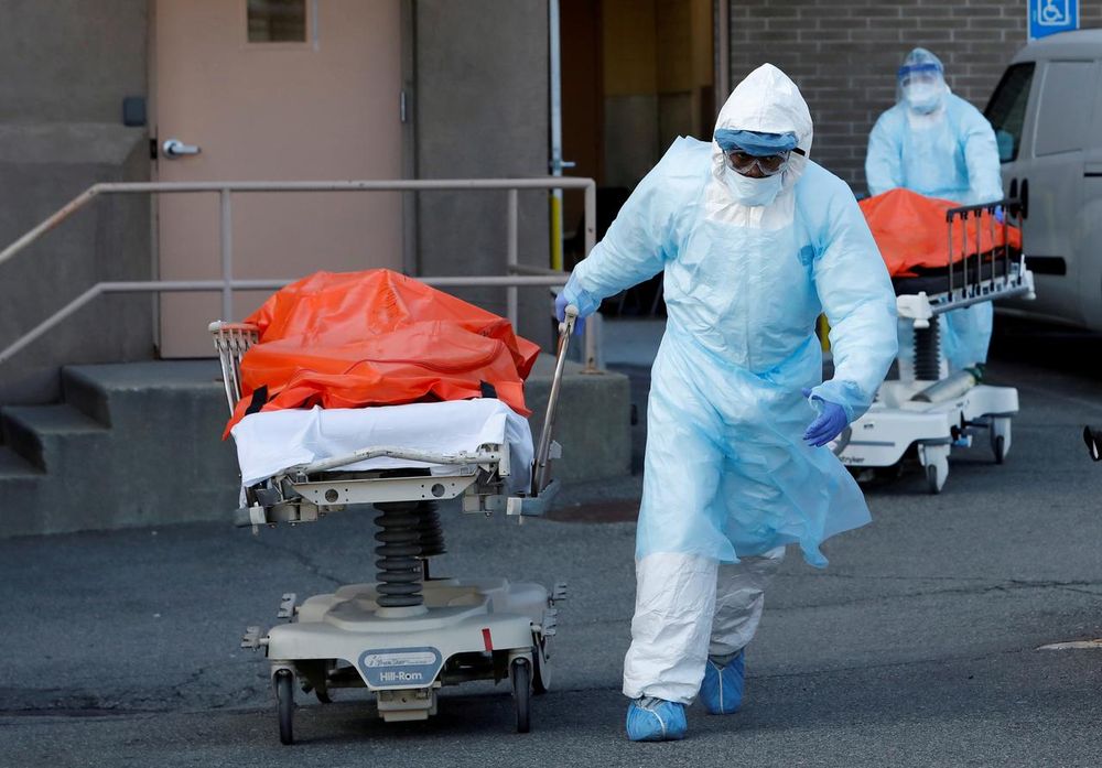 Healthcare workers wheel the bodies of deceased people from the Wyckoff Heights Medical Center during the outbreak of the coronavirus disease (Covid-19) in the Brooklyn borough of New York City, April 4, 2020. u00e2u20acu201d Reuters picn