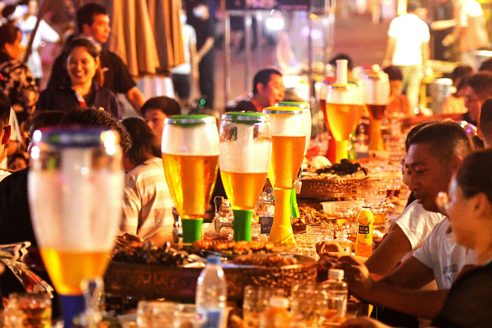 People enjoying beer and food during the annual Qingdao Beer Festival in Qingdao in China's eastern Shandong province. u00e2u20acu201d AFP pic
