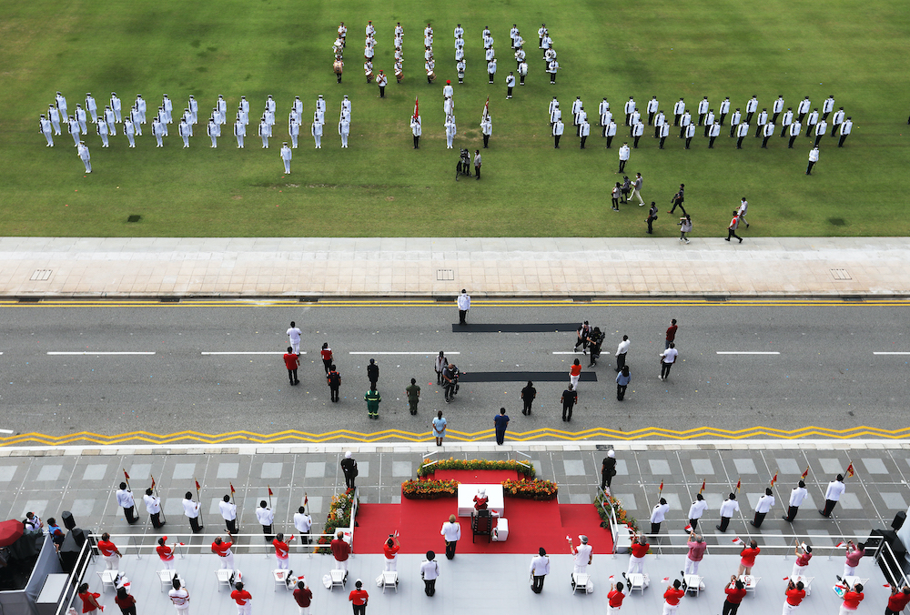 Frontline workers were honoured with a special salute by the guard of honour on National Day at the Padang. — TODAY pic