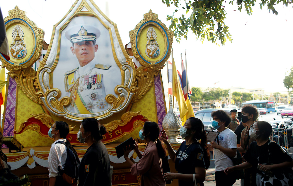 Demonstrators walk past a portrait of Thai King Maha Vajiralongkorn during a protest demanding the resignation of Thailand's Prime Minister Prayut Chan-o-cha, in Bangkok, Thailand July 26, 2020. u00e2u20acu201d Reuters/Jorge Silva pic