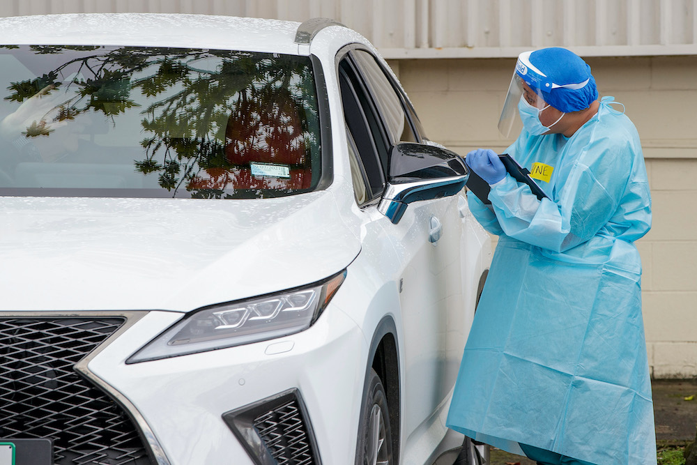 A health worker conducts a test at a Covid-19 coronavirus testing centre in the suburb of Northcote in Auckland August 12, 2020. u00e2u20acu201d AFP pic