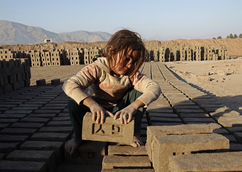 An Afghan girl works at a brick-making factory in Nangarhar province January 6, 2015. u00e2u20acu201d Reuters pic
