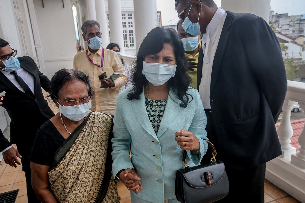 E. Meeriam Rosaline (centre) leaves the Ipoh High Court August 14, 2020. u00e2u20acu201d Picture by Farhan Najib