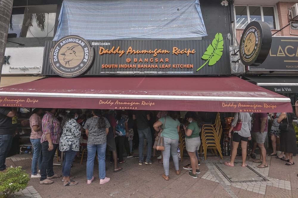 People are seen disregarding social distancing rules while waiting at the entrance of Daddy Arumugam Recipe restaurant in Bangsar August 1, 2020. u00e2u20acu201d Picture by Shafwan Zaidon