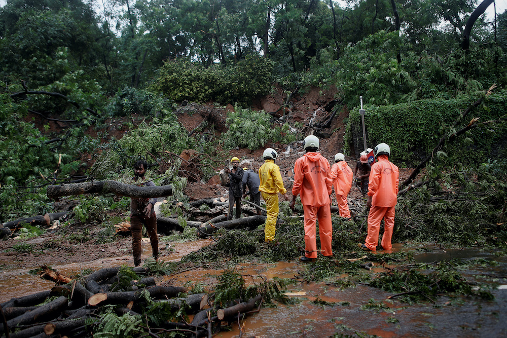 Firefighters and other workers clear debris from a landslide after heavy rainfall in Mumbai, India, August 6, 2020. u00e2u20acu201d Reuters pic