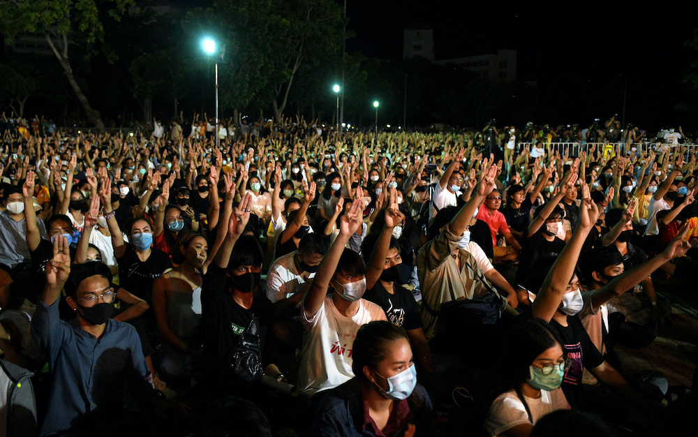 Pro-democracy protesters do a three-fingered salute as they attend a rally to demand the government to resign at Thammasat University's Rangsit campus outside of Bangkok, Thailand August 10, 2020. u00e2u20acu201d Reuters picn n
