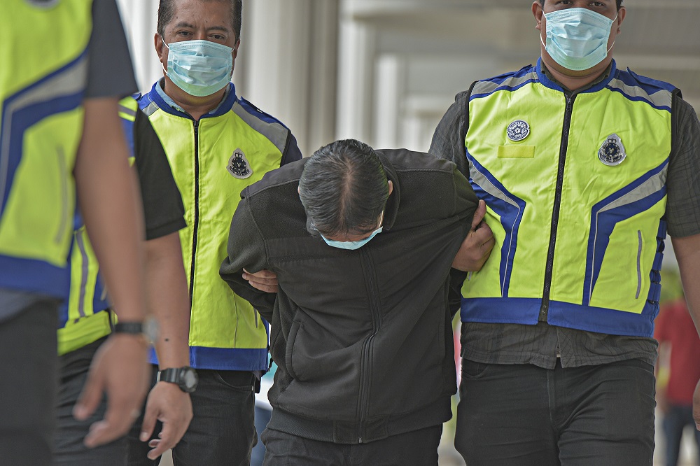 Mohd Hairil Izzuan A. Samad (centre) is accused of murdering 40-year-old Maizatulnisa Othman, under Section 302 of the Penal Code, between 11am on July 29 and 1am on July 30 at the Cyber Valley Park lake, on Jalan Persiaran Sepang, in Cyberjaya, Selangor.
