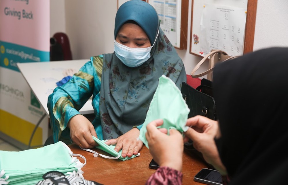 Noraishah Abdullah who has been in the Cuci Ceria initiative enjoys the fellowship she has with her new friends. — Picture by Choo Choy May