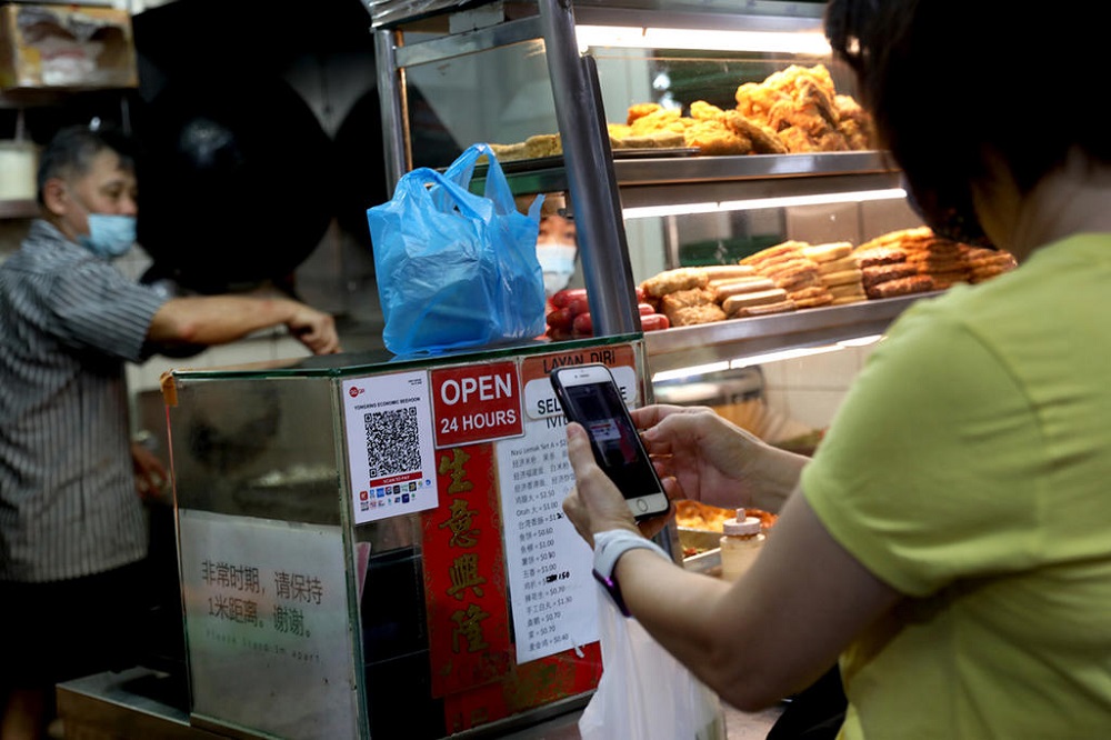 The Hawkers Go Digital programme aims to help 18,000 stallholders adopt digital tools such as e-payments by June next year. u00e2u20acu201d TODAY pic